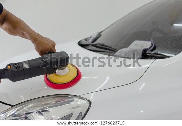 Man working for\
polishing, coating cars.