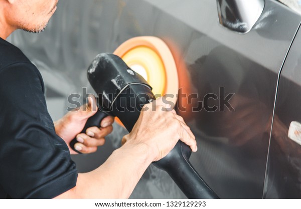 Man working for
polishing, coating cars.