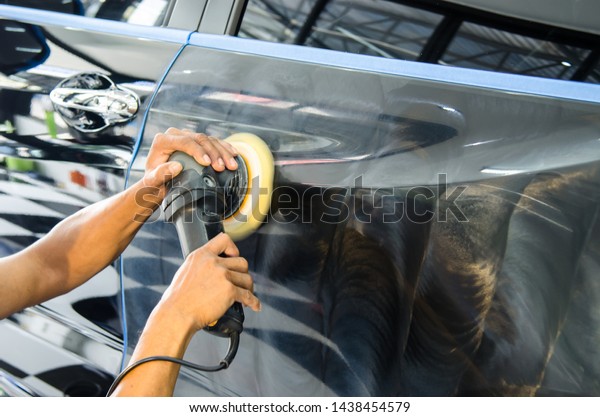 Man working for\
polishing, coating cars.