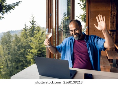 Man working remotely on laptop from mountain cabin - Powered by Shutterstock