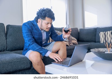 A man working remotely while drinking wine