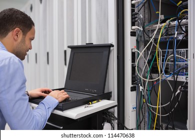 Man working with servers in data center