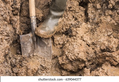 Man Working with a shovel in clay