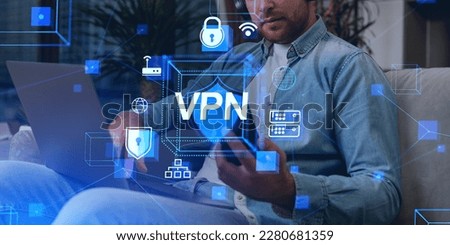Man working with smartphone and laptop, VPN and internet privacy hologram. Data storage and protection in cyberspace, digital icons hologram. Concept of anonymous connection and privacy