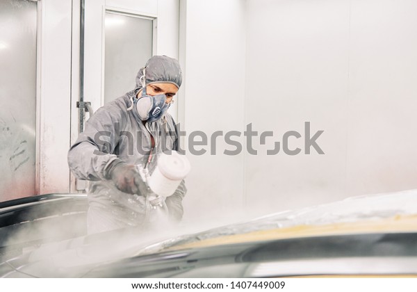 a man working\
with a suite and mask\
painting