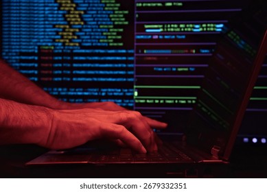 Man working and typing command lines on PC. Using technology to hack a system. IT engineer, software developer, and programmer writing code. Concept of hacking and system invasion. Low light.