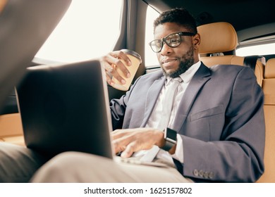 Man Working Under A Project On His Laptop And Holding Coffee Cup.