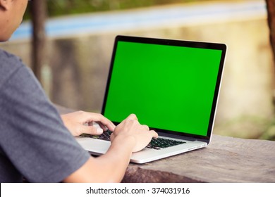 A Man Is Working Using Laptop At Park / Outdoor, Blank Screen For Background