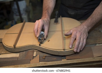 Man working at a Workshop with Musical instruments