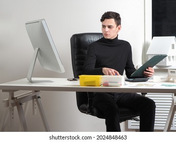 Man Works In An Architectural Workshop. Working On A Cottage Project. Construction Engineer Is Developing Private House Project. The Architect At His Desk. Civil Engeneer In The Architectural Bureau.