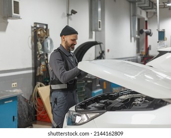 the man works at a car service station. car repair shop worker