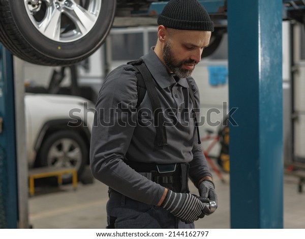 the man works at a car service station. car repair
shop worker