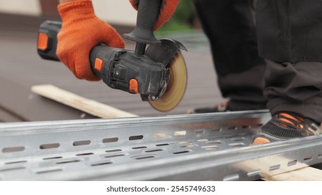 Man works circular saw. Sparks fly from hot metal. Man hard worked over the steel. Male hand cuts off pieces of pipe with angle grinder. Cutting of a steel with splashes of sparks at construction site - Powered by Shutterstock