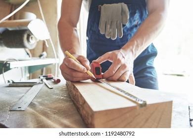 A man works in a joiner's shop, working with a tree