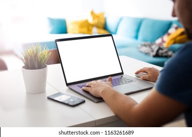 Man Works On A Blank Screen Laptop In A Home Interior - Mockup, Template