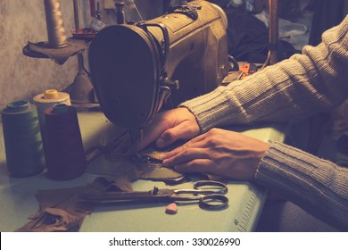 Man Works On Sewing Machine.