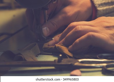 Man Works On Sewing Machine.