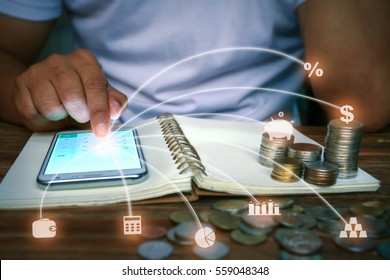 A Man Works With Smart Phone Calculator App, Rows Of Coins On Book, Banking And Saving Concept With Money And Finance Icons., Soft Focus At Finger.