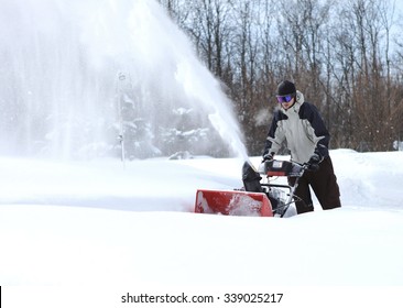 A Man Works Snow Blowing Machine