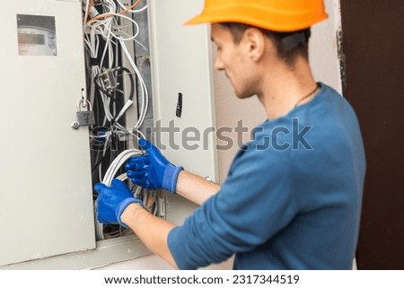 A man works with telecommunications. The technician switches the Internet cable of the powerful routers