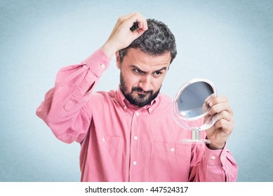 Man Worried About Gray Hair Looking In A Mirror