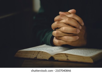 Man worship pray for god blessing to wishing have a better life. Man hands holding praying to god with the bible. christian life crisis prayer to god concept