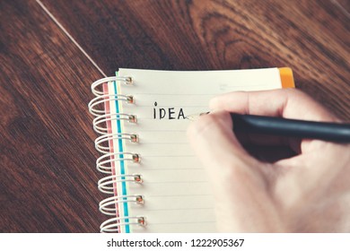man writeen idea text on notepad
