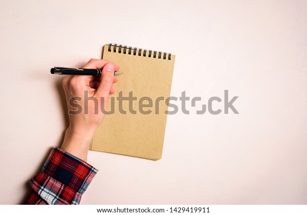 Man writing by left hand. Left hander day concept.\
Working place of lefty