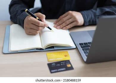 Man Writing Credit Card Expense Record. Financial Planning And Cost Reduction.