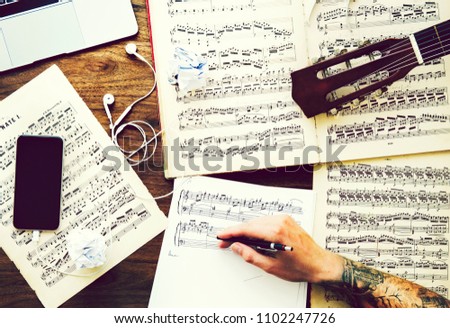 Man writing down notes for a new composition
