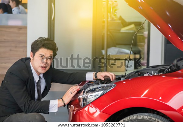 Man writing note on book, paper or notepad with\
blurred engine background.For automotive, transportation\
maintenance image.