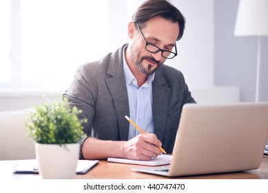 Man writing in the notebook - Shutterstock ID 440747470
