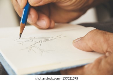 Man Writing On Sketchbook