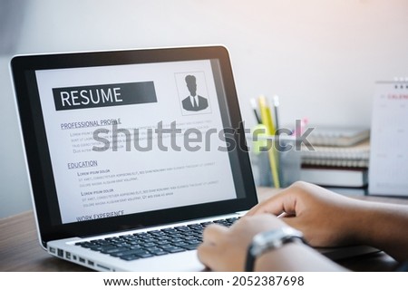 Man writing resume and CV in-home office with laptop. before send for new work and typing curriculum vitae for application. Job seeking, hunt, and unemployment