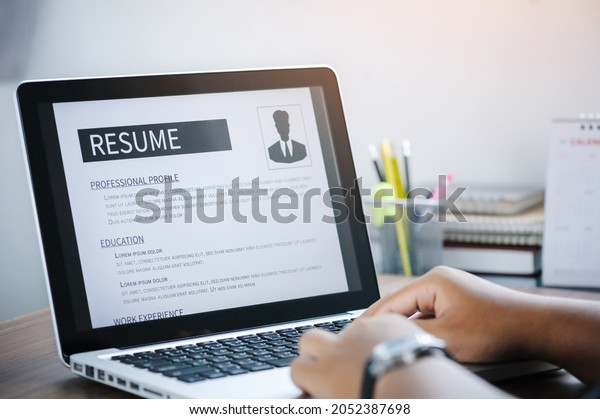 Man writing resume and CV in-home\
office with laptop. before send for new work and typing curriculum\
vitae for application. Job seeking, hunt, and\
unemployment