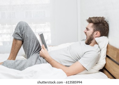 Man Yawning And Reading Book After Wake Up In The Morning