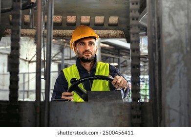 man in a yellow helmet and safety vest is driving a forklift. Concept of responsibility and caution, as the man is wearing a hard hat and safety gear while operating the forklift - Powered by Shutterstock