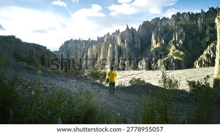 Man in Yellow Jacket Overlooking the Dramatic Spired Peaks of Valle de las Animas in La Paz, Bolivia