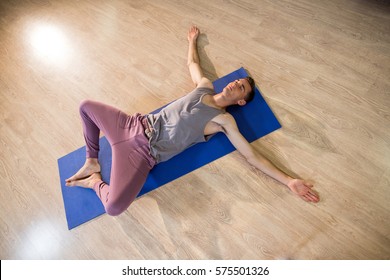 Man In Yoga Corpse Pose In Gym