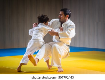 Man and young boy are training judo throwing