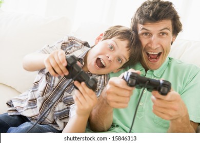 Man and young boy with video game controllers smiling - Powered by Shutterstock