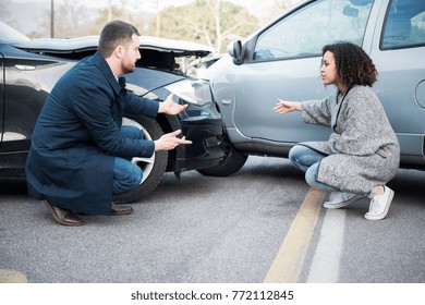 Man And Young Woman Arguing After Bad Car Crash