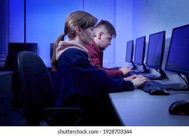 A man with a young woman working in an office. Esports player. Computer room. Work in the office. - Shutterstock ID 1928703344