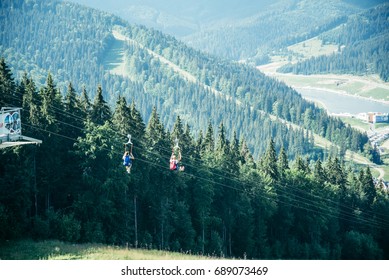 Man Zipline Flight In Moutains In Sunny Day