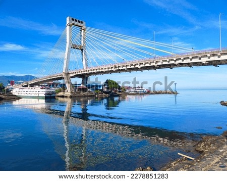Manado, Indonesia – March 19, 2023: Soekarno bridge is one of icon at the Manado City, North Sulawesi. This brigde have leght about 1127 meter.  The view of Soekarno bridge with beautiful