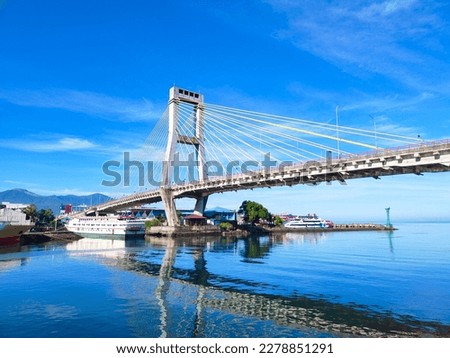 Manado, Indonesia – March 19, 2023: Soekarno bridge is one of icon at the Manado City, North Sulawesi. This brigde have leght about 1127 meter.  The view of Soekarno bridge with beautiful