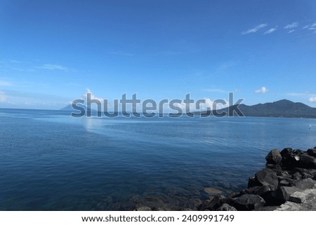 Manadotua Island and Tumpa Mountain seen from Manado City Indonesia