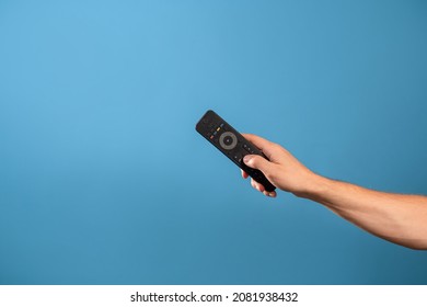 Manage home appliances, elements of a smart home with remote control, comfort for life. The control panel is in a man's hand. Photo on a blue background - Shutterstock ID 2081938432
