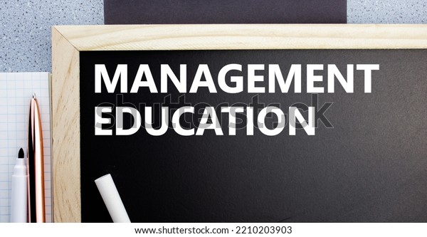 The management education\
inscription on a chalk board.The concept of getting education in\
the field of\
management,trade,business.