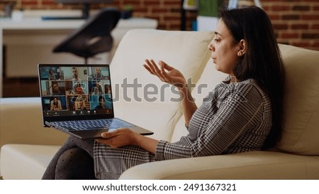 Management executive remotely delegating project tasks to employees during teleconference meeting. Indian manager at home holding online videocall with international multiethnic team